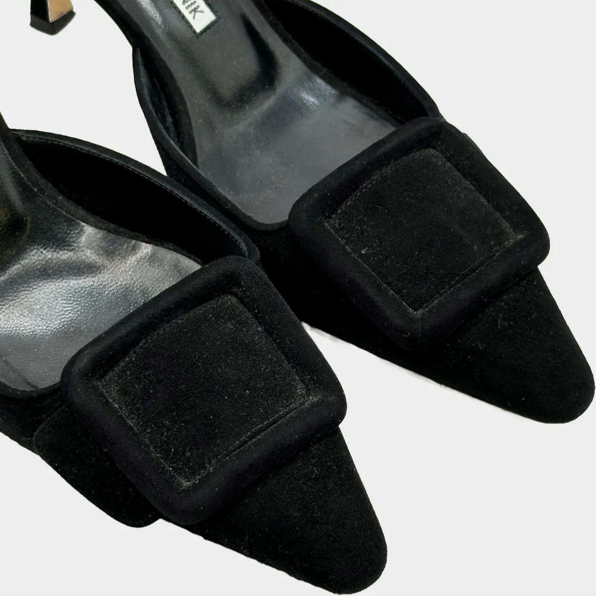 Manolo Blahnik black suede open back pumps with buckle detail at the toes
